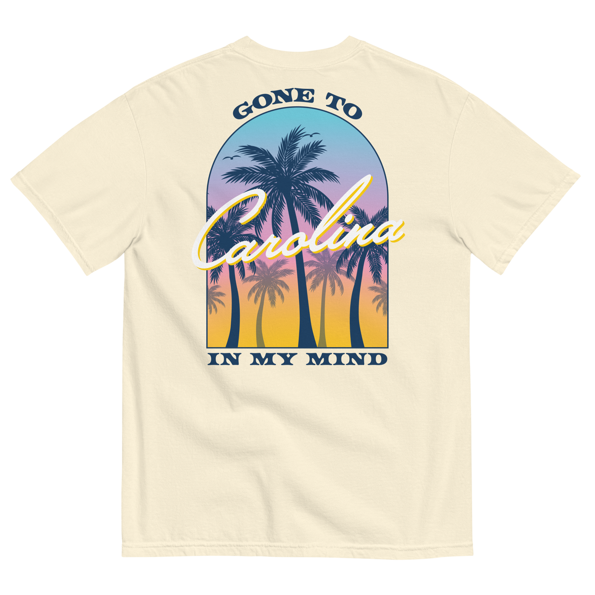 Back of ivory tee with palm trees against a colorful sunset and ‘Gone to Carolina in My Mind’ lettering.