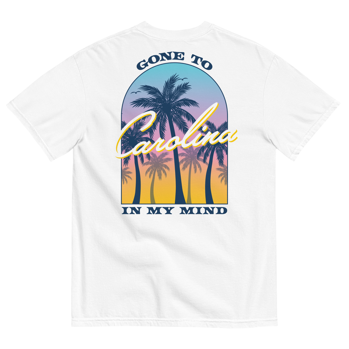 Back of white tee with palm trees against a colorful sunset and ‘Gone to Carolina in My Mind’ lettering.
